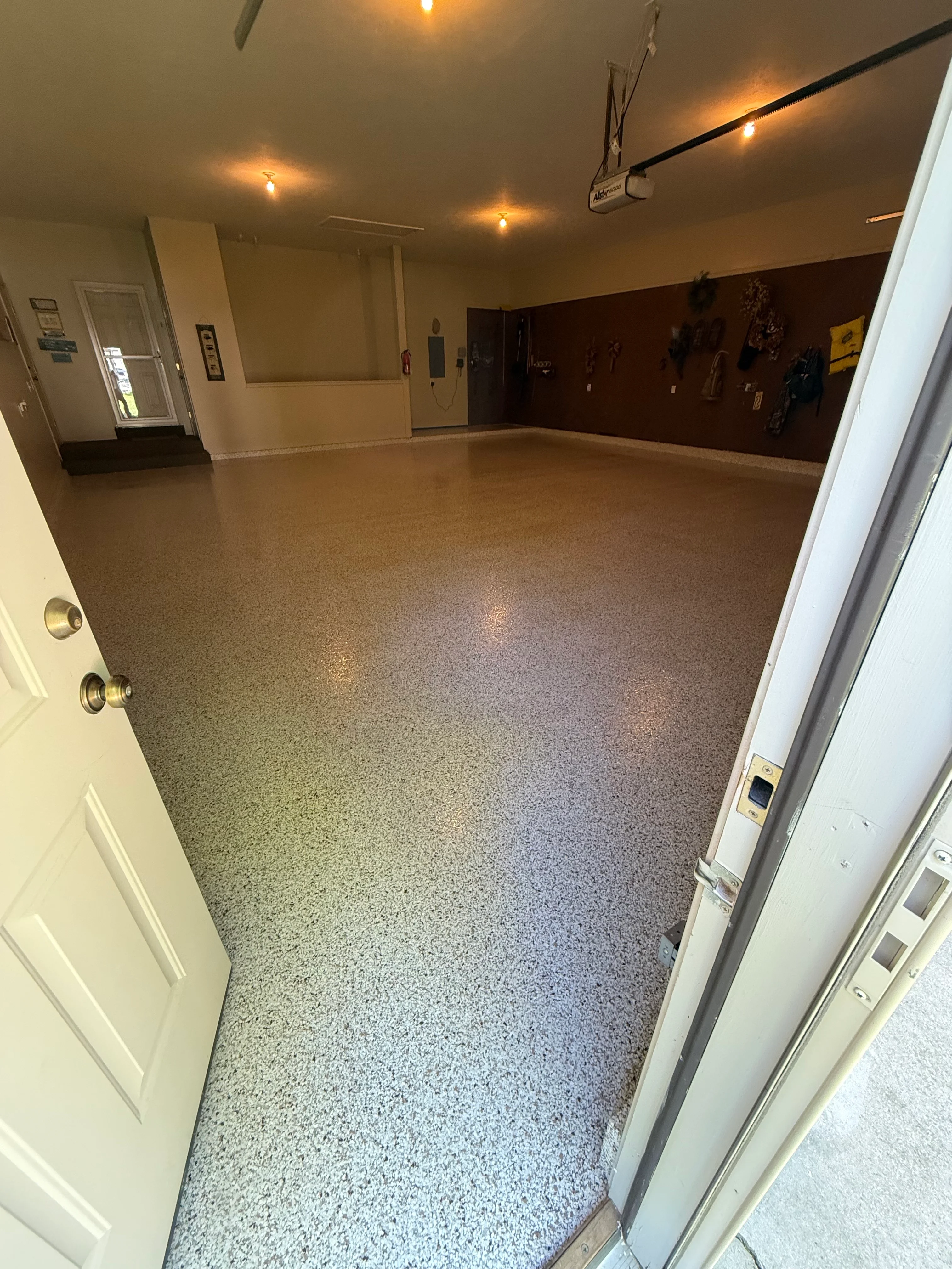 Finished epoxy floor with speckled gray coating in commercial space with recessed lighting